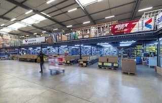 Operators perform batch picking in the warehouse using carts Operators perform batch picking in the warehouse using carts